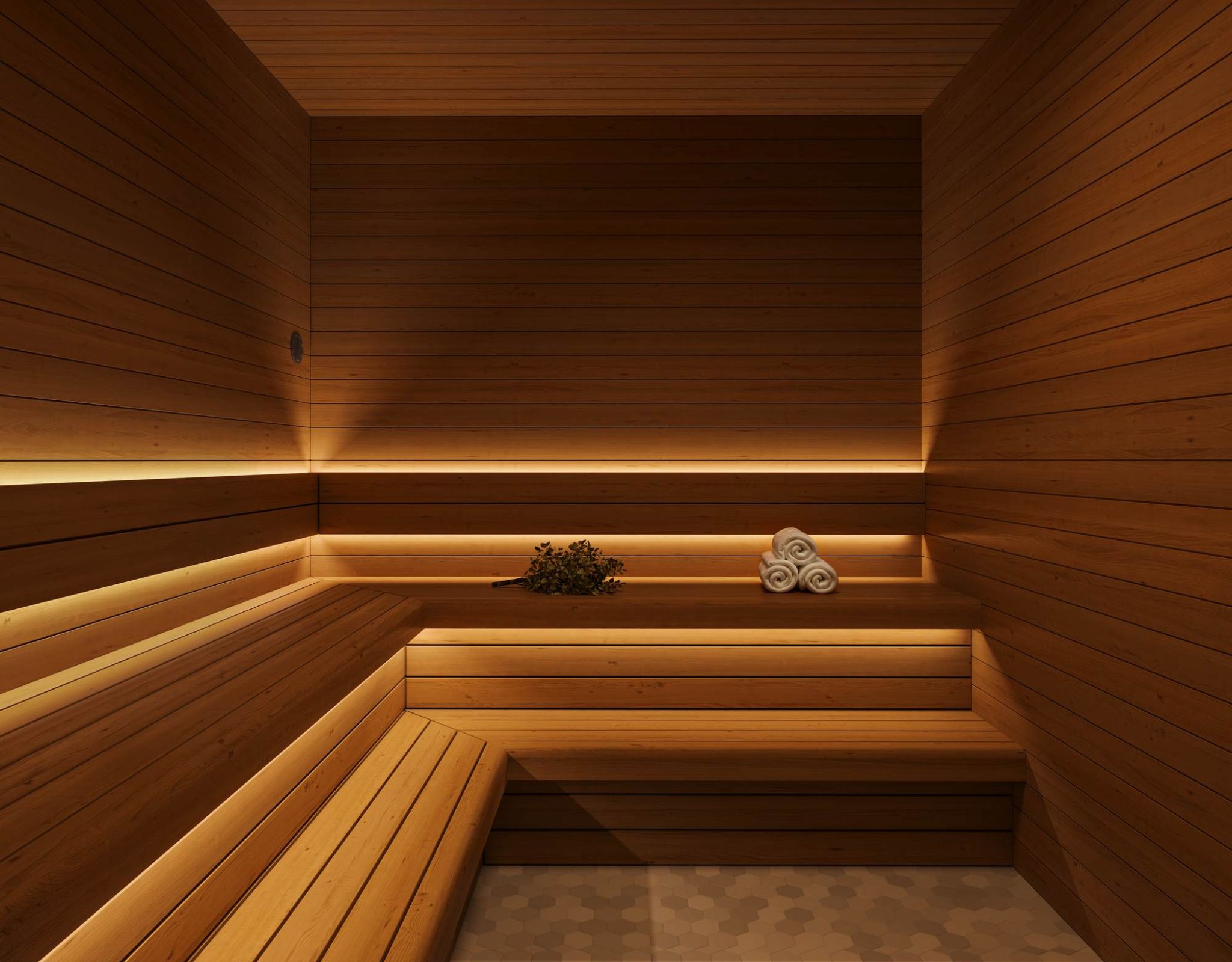 Wood-paneled sauna at VERVE Columbia featuring warm ambient lighting, tiered bench seating, and rolled towels—designed for relaxation and post-workout recovery.