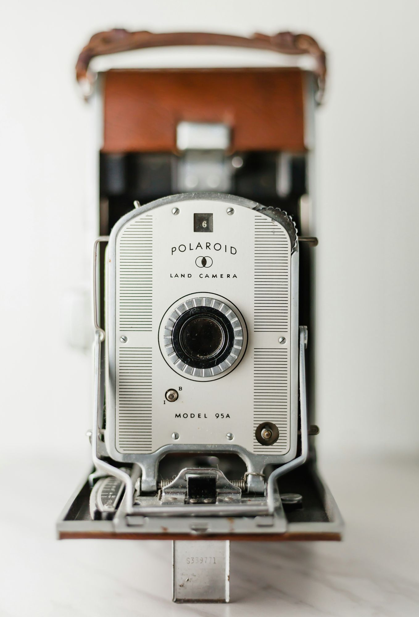 Close-up of a vintage Polaroid Model 800 camera with a white and silver faceplate, captured as part of the VERVE Columbia lifestyle series